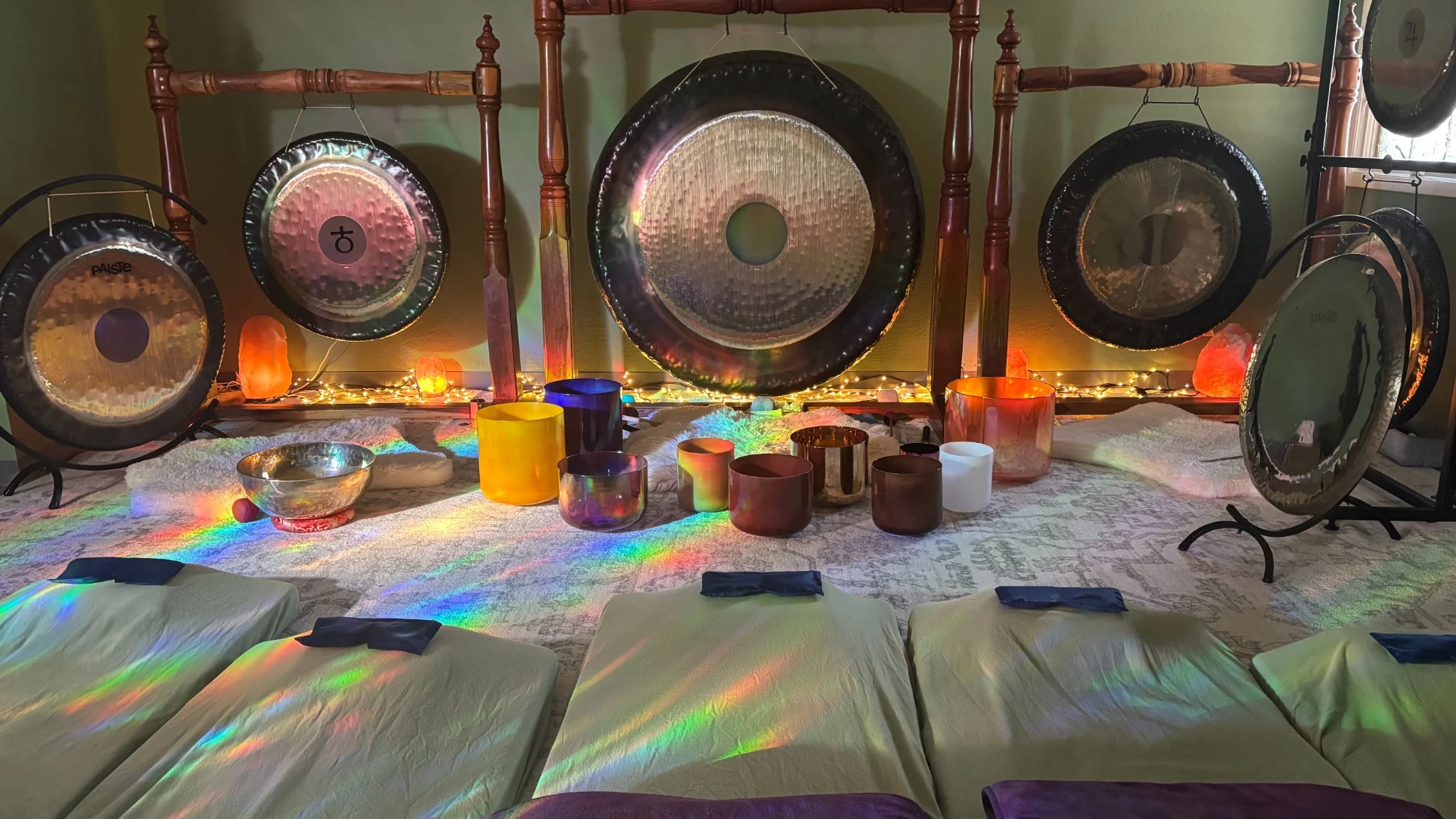 Sound healing room at Sedona Crystal Temple with crystal singing bowls, cushioned beds and large Paiste gongs